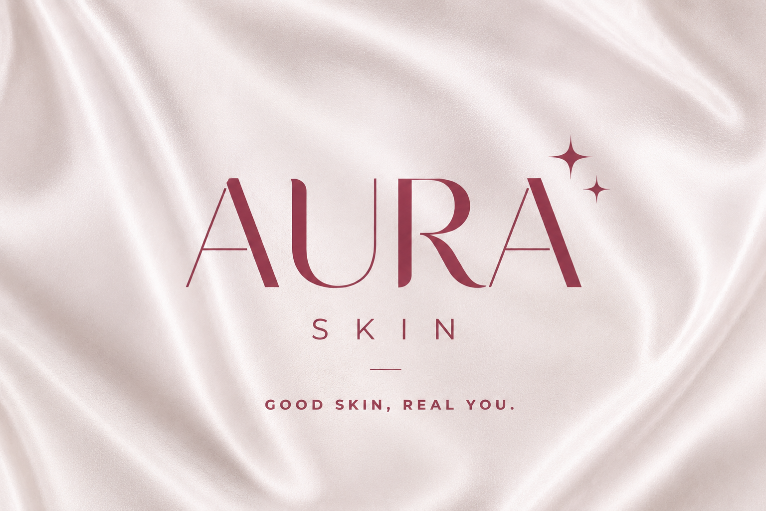 Aura Skin logo featuring a luxury serif font and the tagline "Good Skin, Real You" on a silk background.